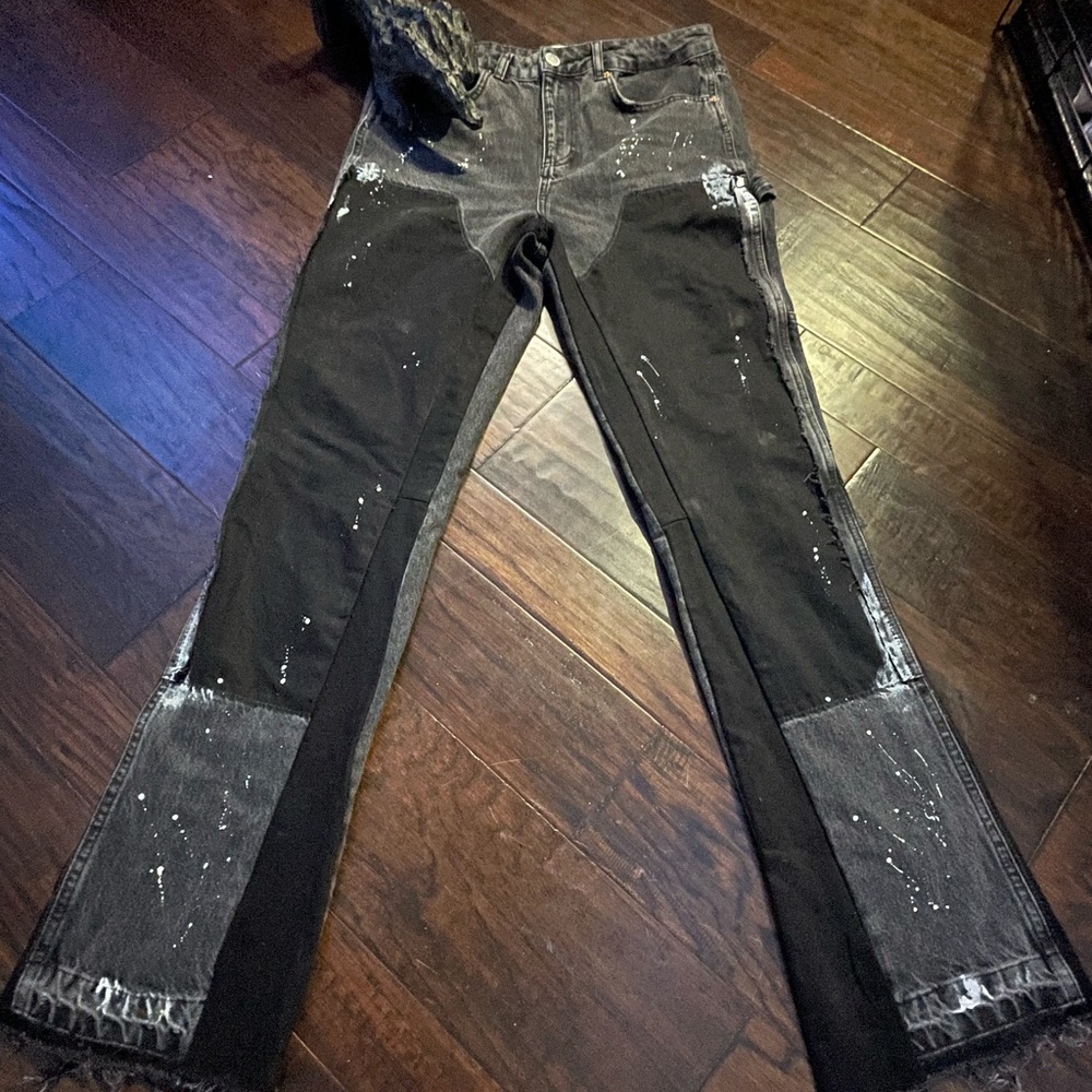 Black stacked pants with paint